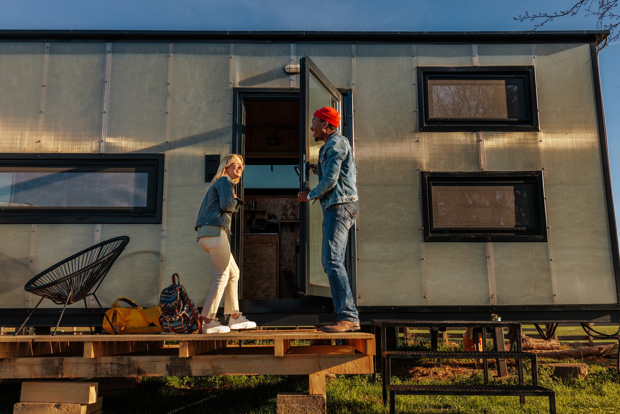 glamping furniture -- couple outside of glamping trailer