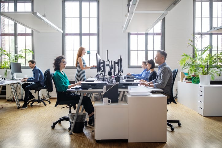 People sitting in an office. Why Ergonomics Is Important in Workplace.