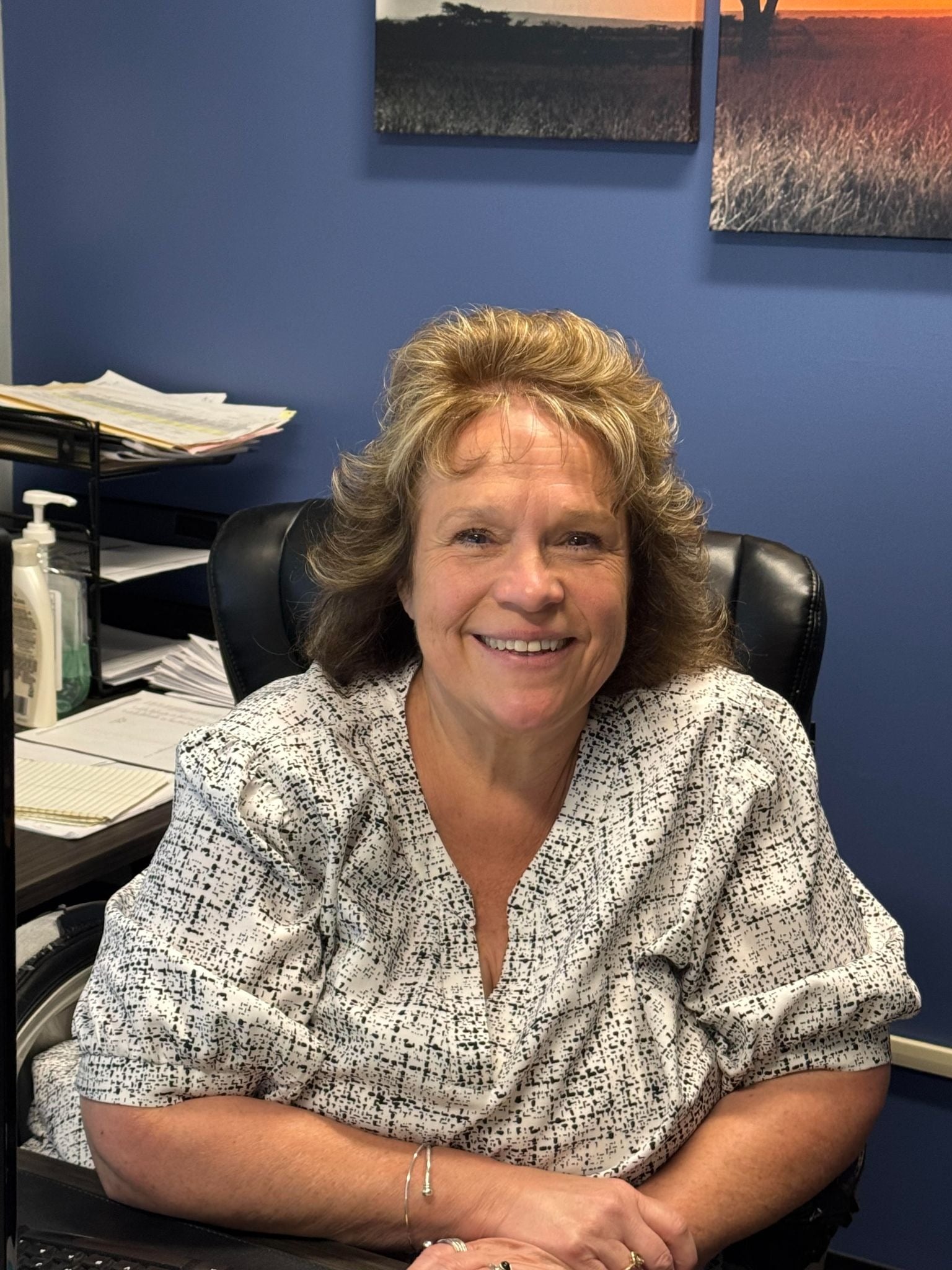 Kelly Workman, Purchasing Manager at Weber Knapp, seated at her desk
