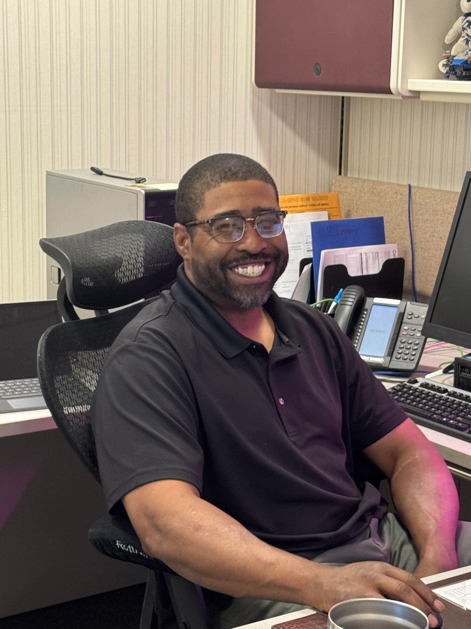 Henry Leeper, Network Admin Assistant, at his workstation at Weber Knapp